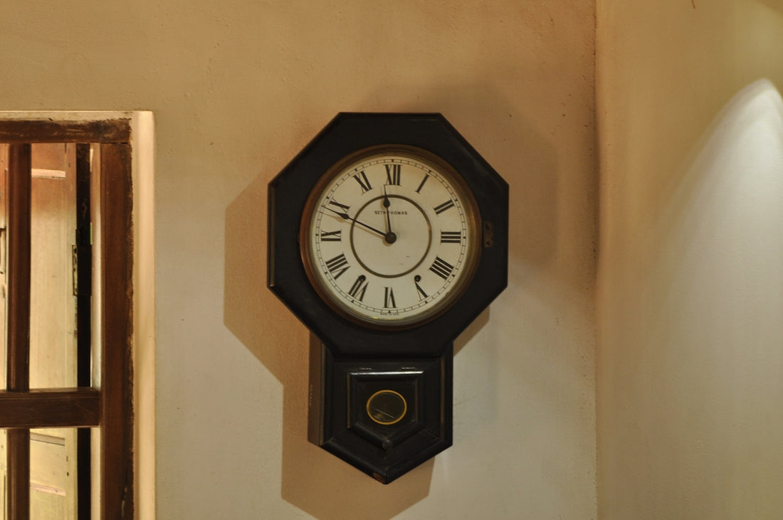 A vintage clock hangs on the wall.